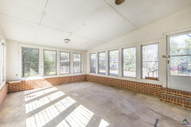 unfurnished sunroom with lofted ceiling