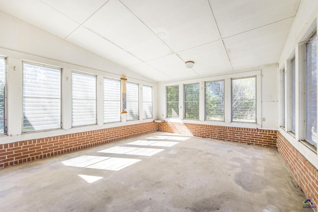 unfurnished sunroom with lofted ceiling