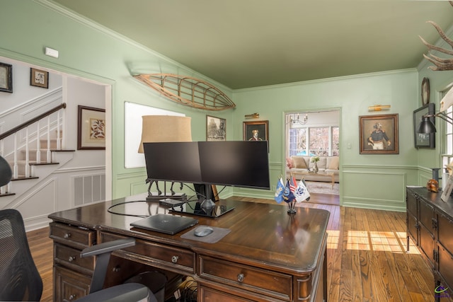 home office featuring a decorative wall, ornamental molding, and hardwood / wood-style flooring