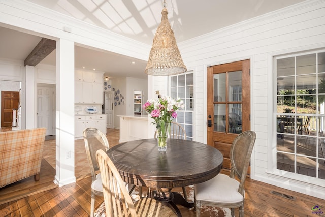 dining room featuring visible vents and wood finished floors