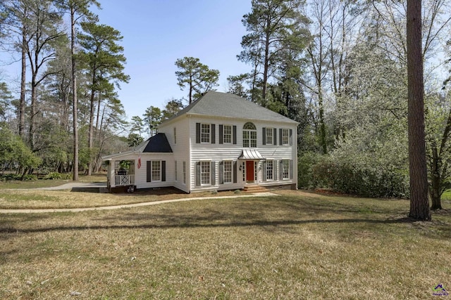 colonial house featuring a deck and a front lawn