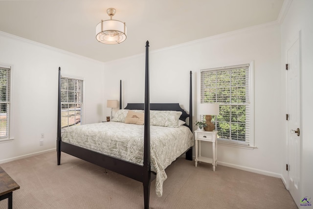 carpeted bedroom featuring crown molding and baseboards