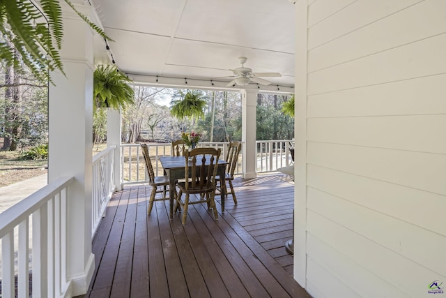 deck featuring outdoor dining area and ceiling fan