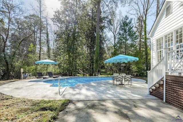 outdoor pool featuring a patio area and outdoor dining space