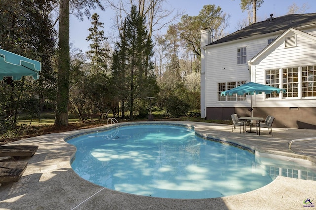 outdoor pool with a patio area