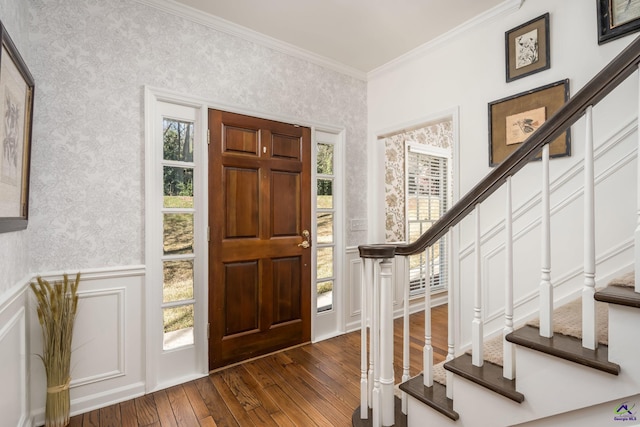 entryway with wainscoting, stairs, and wallpapered walls