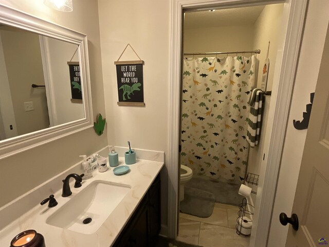 full bath with a shower with curtain, toilet, vanity, and tile patterned flooring