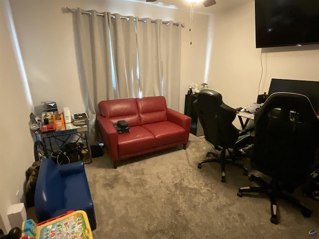 carpeted home office featuring a ceiling fan