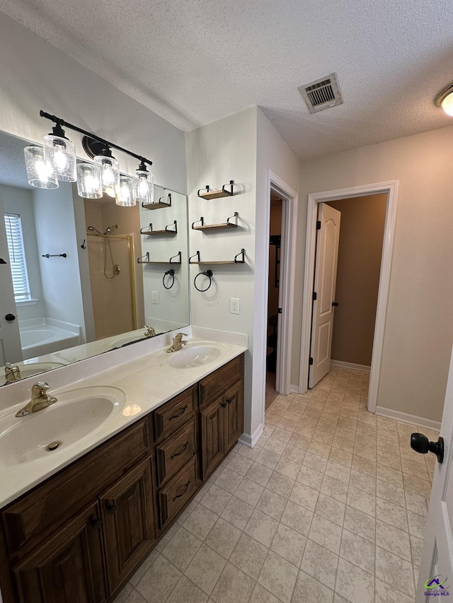 full bathroom featuring a sink, visible vents, a bath, and a shower stall