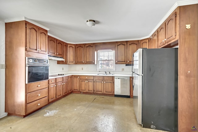 kitchen with under cabinet range hood, black appliances, brown cabinetry, and light countertops