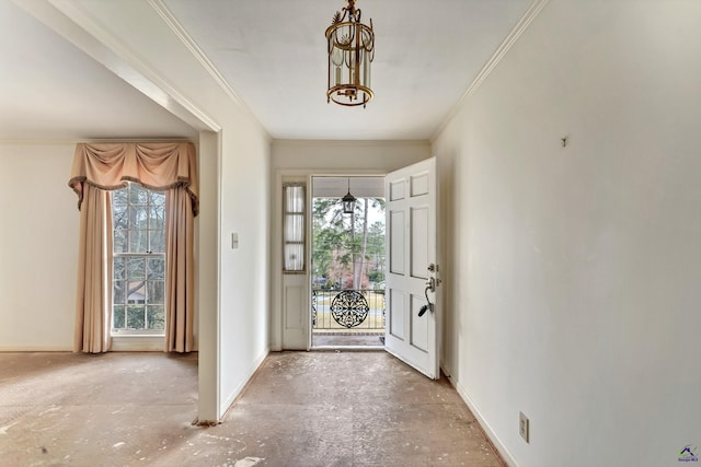 foyer with crown molding, a notable chandelier, and baseboards