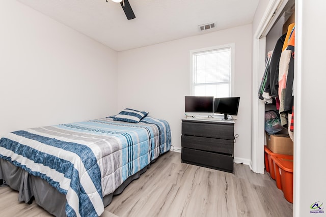 bedroom featuring visible vents, ceiling fan, and wood finished floors