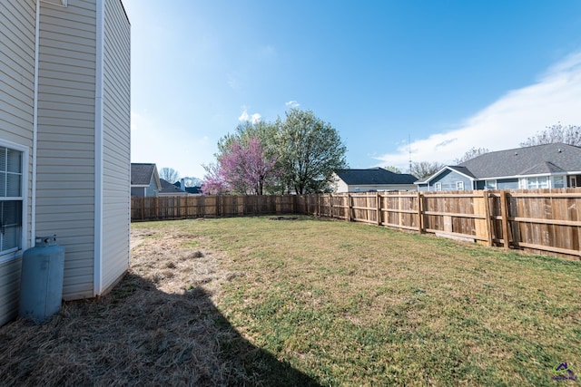 view of yard with a fenced backyard