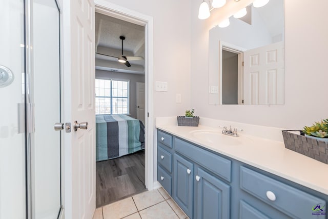 full bath with a shower with door, connected bathroom, vanity, and tile patterned flooring