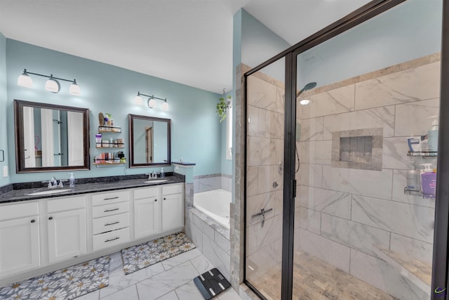 full bathroom featuring a bath, a shower stall, double vanity, and a sink