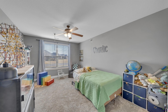 carpeted bedroom featuring a ceiling fan and baseboards