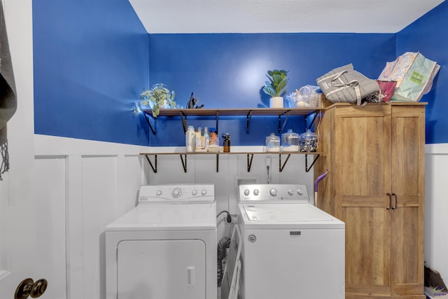 washroom featuring cabinet space and washer and dryer