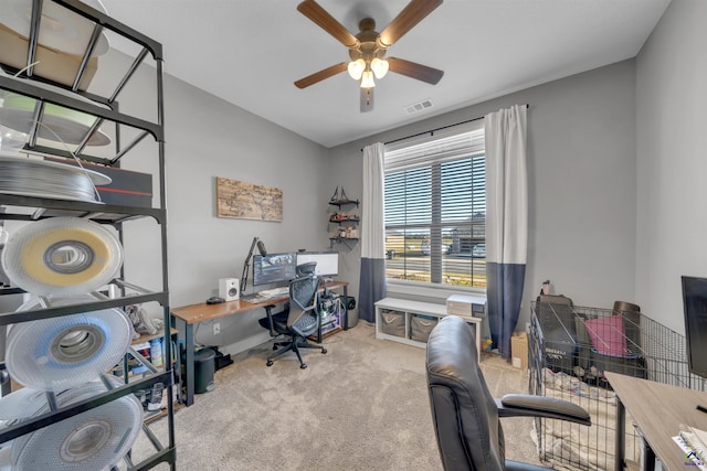 home office with visible vents, ceiling fan, and carpet flooring