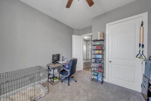 carpeted office space with a ceiling fan