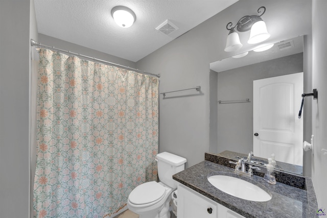 full bathroom with vanity, toilet, visible vents, and a textured ceiling