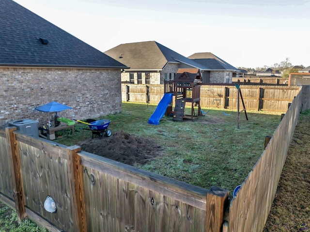 view of play area with a yard and a fenced backyard