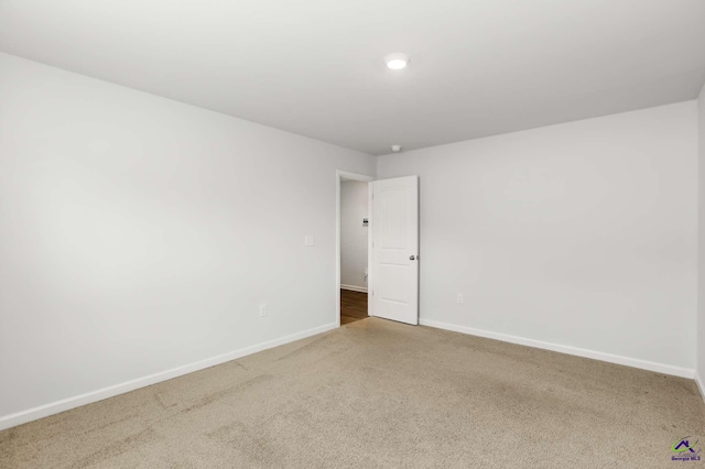 carpeted spare room with baseboards