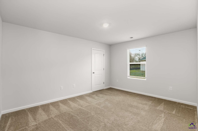 empty room with carpet flooring and baseboards