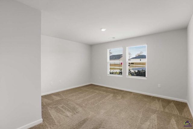 unfurnished room featuring baseboards and carpet floors