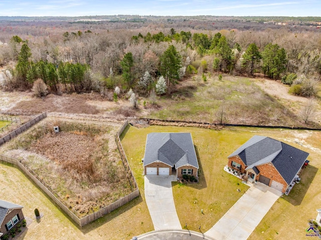 birds eye view of property with a wooded view