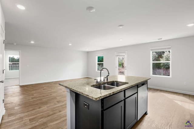 kitchen featuring a sink, dishwasher, open floor plan, and recessed lighting