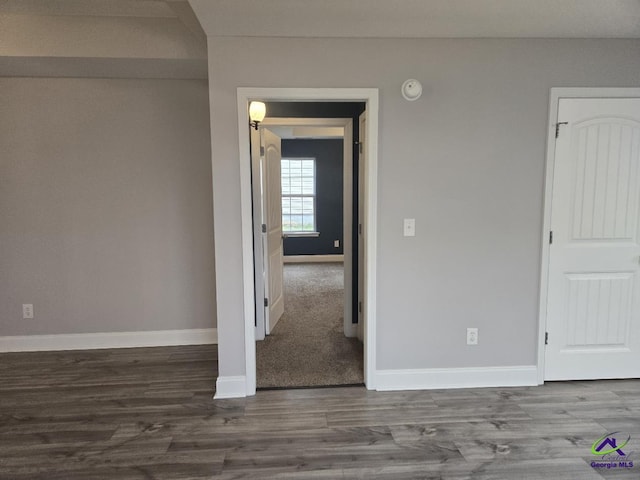 empty room featuring baseboards and wood finished floors