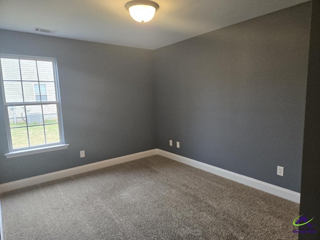 carpeted empty room featuring visible vents and baseboards