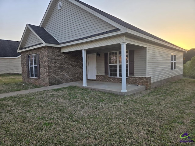 view of front facade with a front yard and brick siding