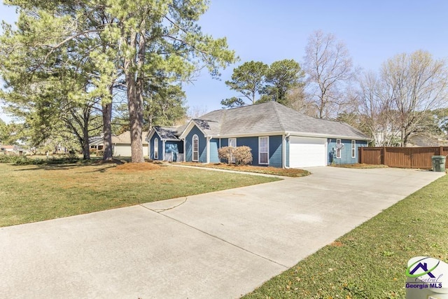 ranch-style house featuring an attached garage, concrete driveway, a front yard, and fence