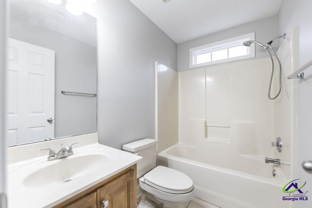 bathroom featuring vanity, toilet, and tub / shower combination