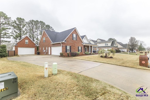 traditional home with brick siding, concrete driveway, and a front yard