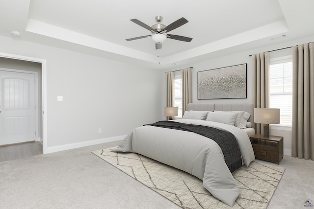 bedroom featuring visible vents, multiple windows, and a raised ceiling