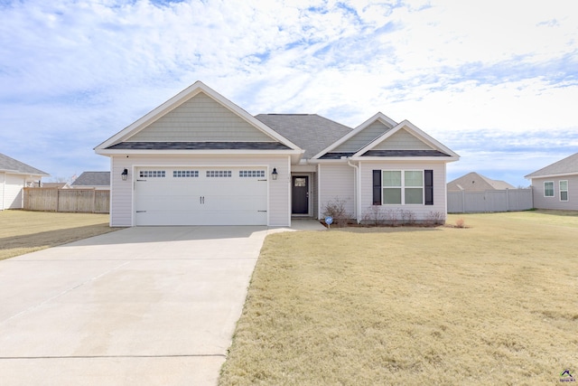 craftsman-style house with a front lawn, an attached garage, driveway, and fence