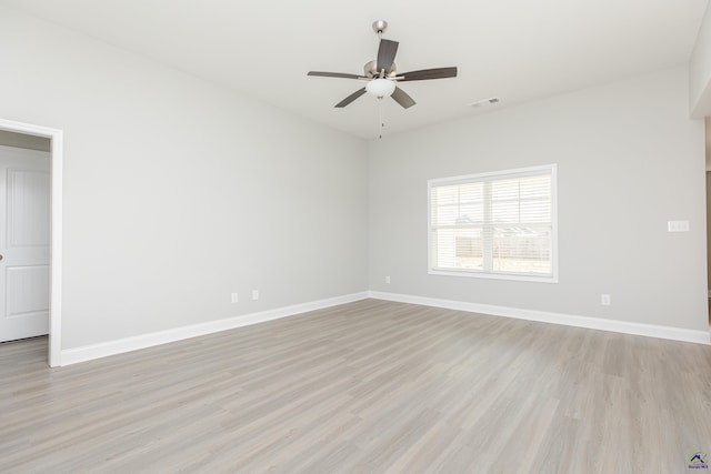 unfurnished room featuring visible vents, light wood-style flooring, a ceiling fan, and baseboards