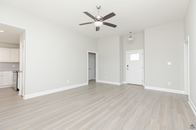 unfurnished living room with light wood-style flooring, baseboards, and a ceiling fan