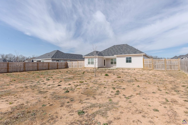 back of house featuring a fenced backyard