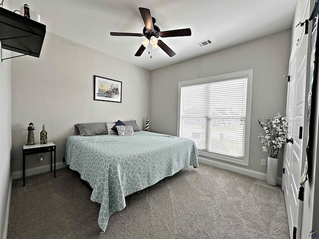 carpeted bedroom featuring visible vents, ceiling fan, and baseboards