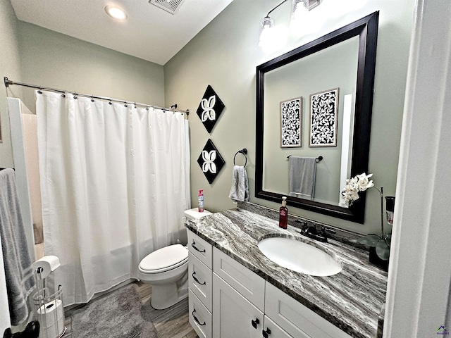 full bathroom with visible vents, shower / bath combo with shower curtain, toilet, and vanity