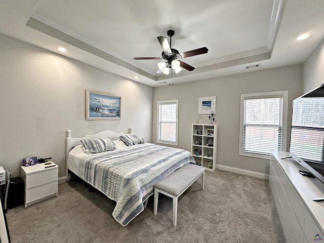 bedroom with visible vents, a tray ceiling, recessed lighting, carpet, and baseboards