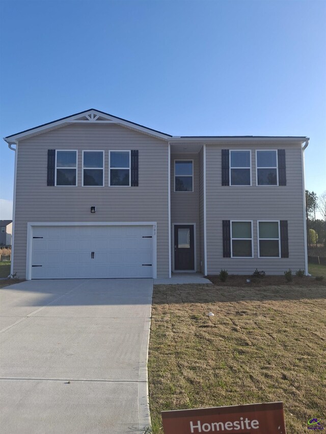 303 Cody Dr, Macon, GA 31216 - view of front of home featuring a garage, a front yard, and driveway