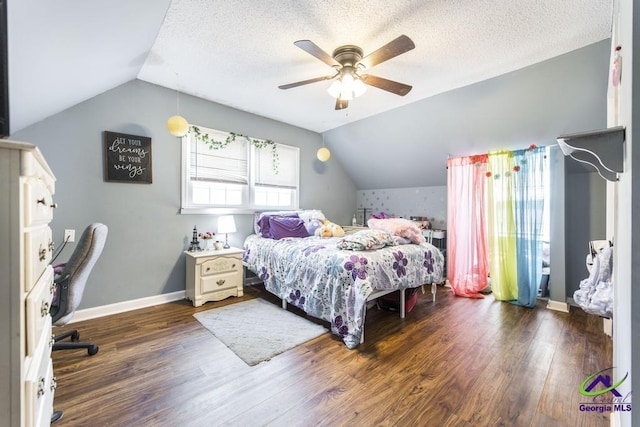 bedroom with wood finished floors, vaulted ceiling, ceiling fan, baseboards, and a textured ceiling