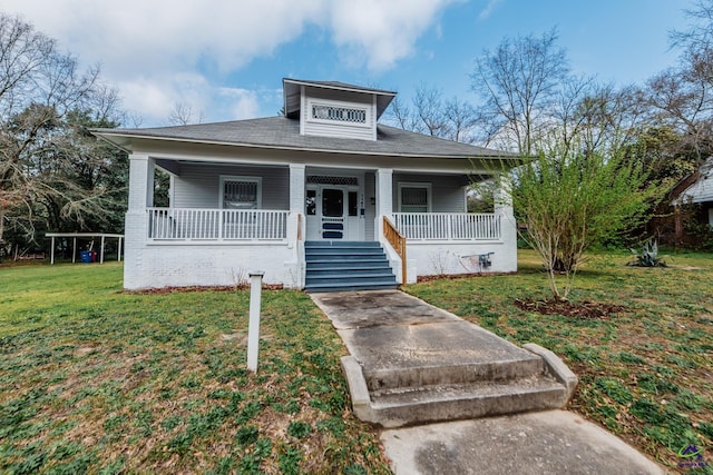 bungalow-style house featuring a porch and a front lawn