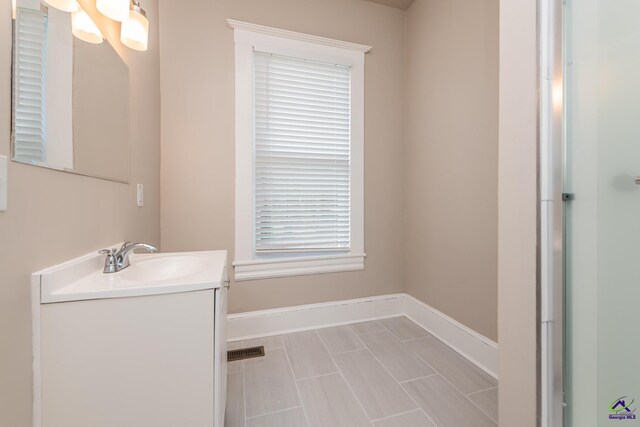 bathroom with visible vents, vanity, and baseboards