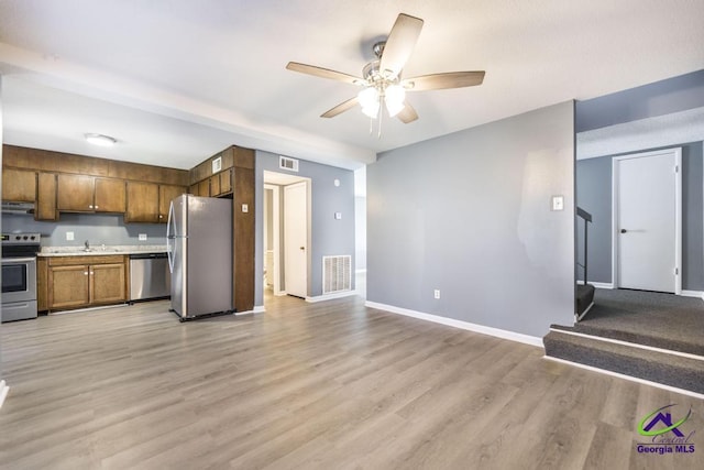 127 Stoneridge Dr, Warner Robins, GA 31088 - kitchen with brown cabinetry, visible vents, ceiling fan, stainless steel appliances, and light countertops
