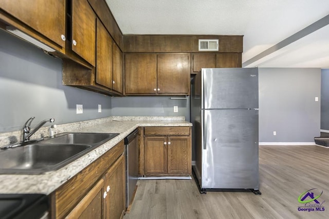 127 Stoneridge Dr, Warner Robins, GA 31088 - kitchen featuring visible vents, light countertops, light wood-style flooring, appliances with stainless steel finishes, and a sink